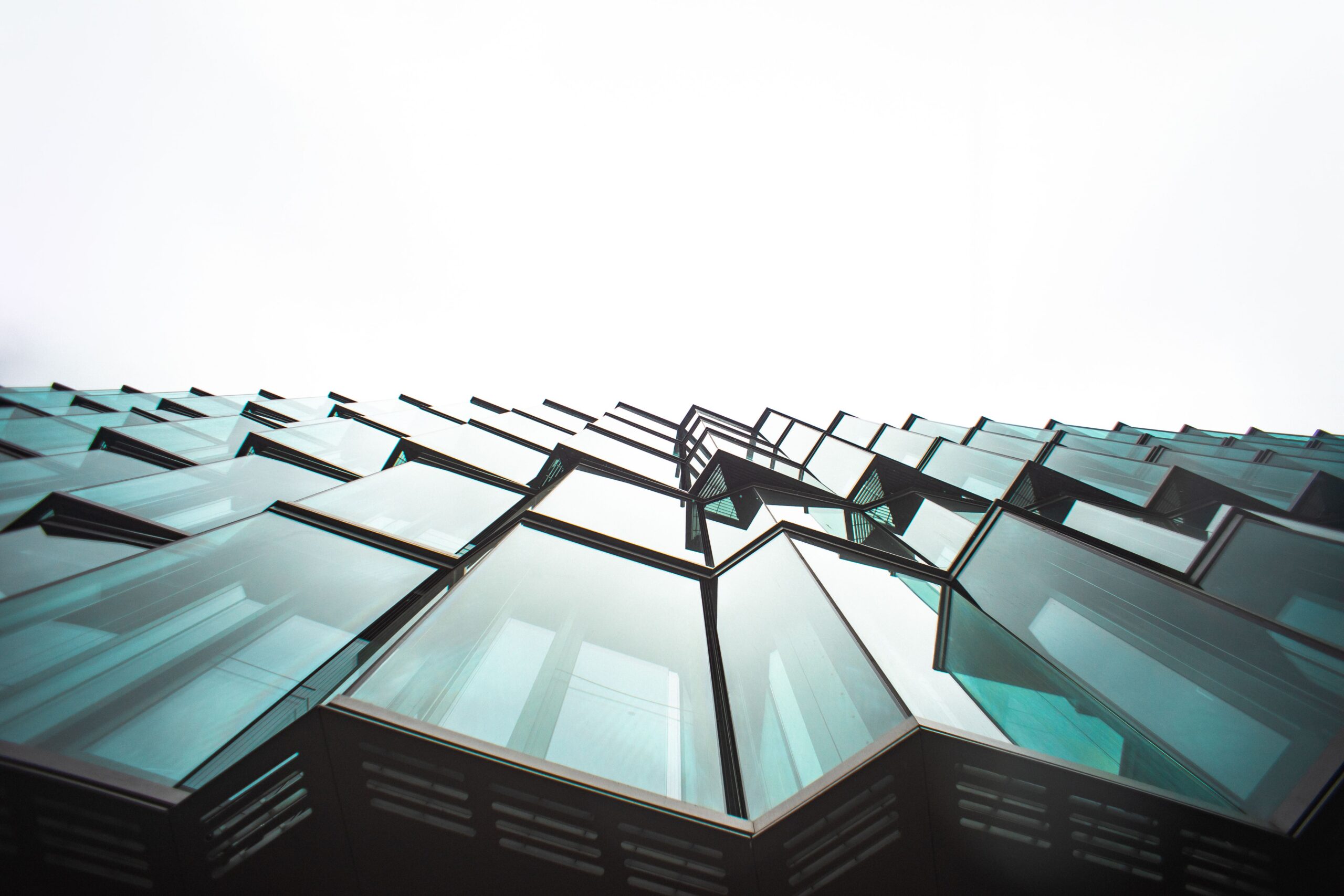 Low angle view of a modern building's glass facade, showcasing architectural design.